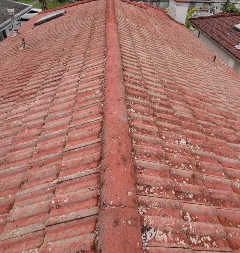 A cleared clay tile roof photographed down the ridge